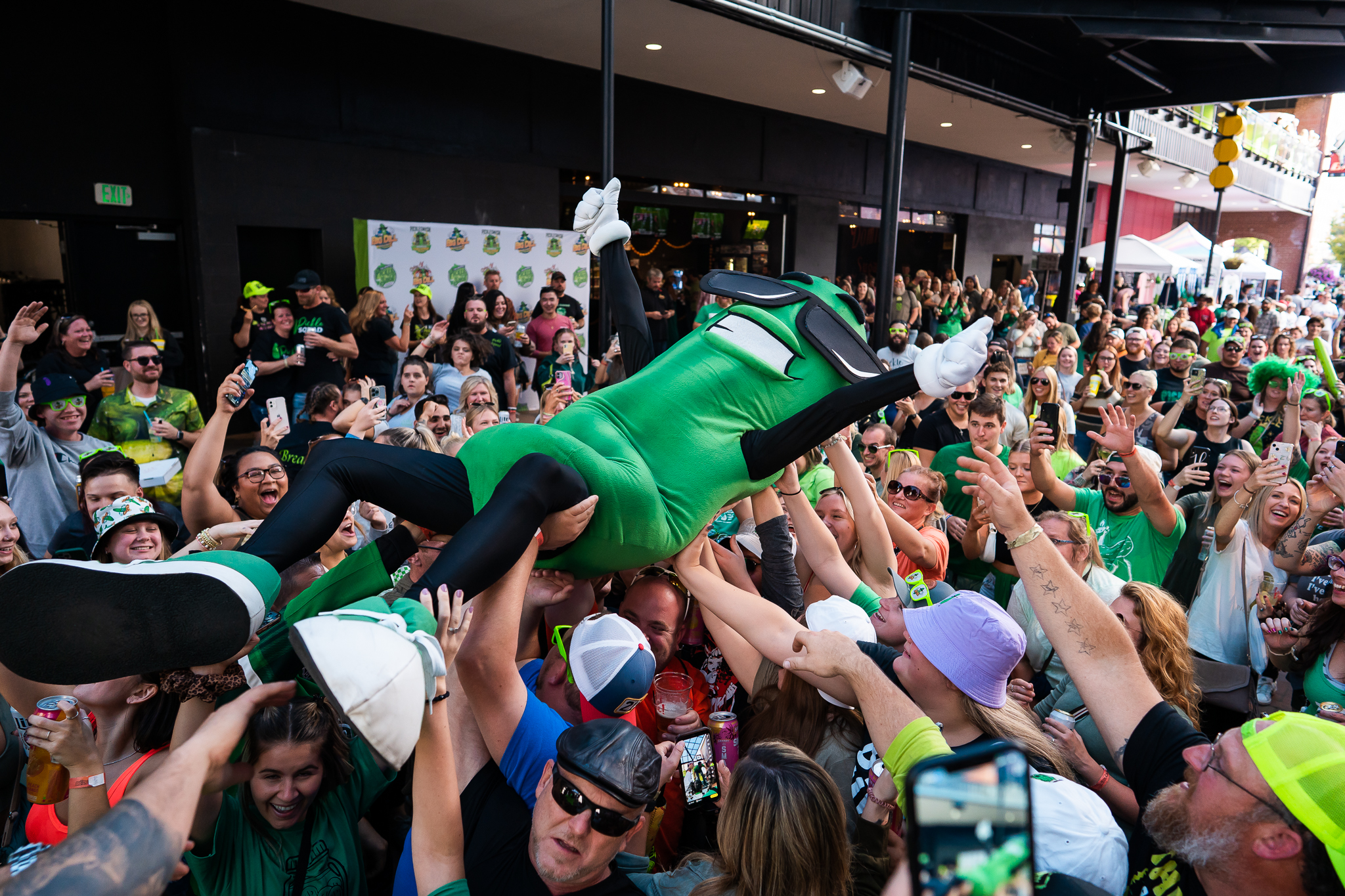 A person dressed as a pickle goes crowdsurfing