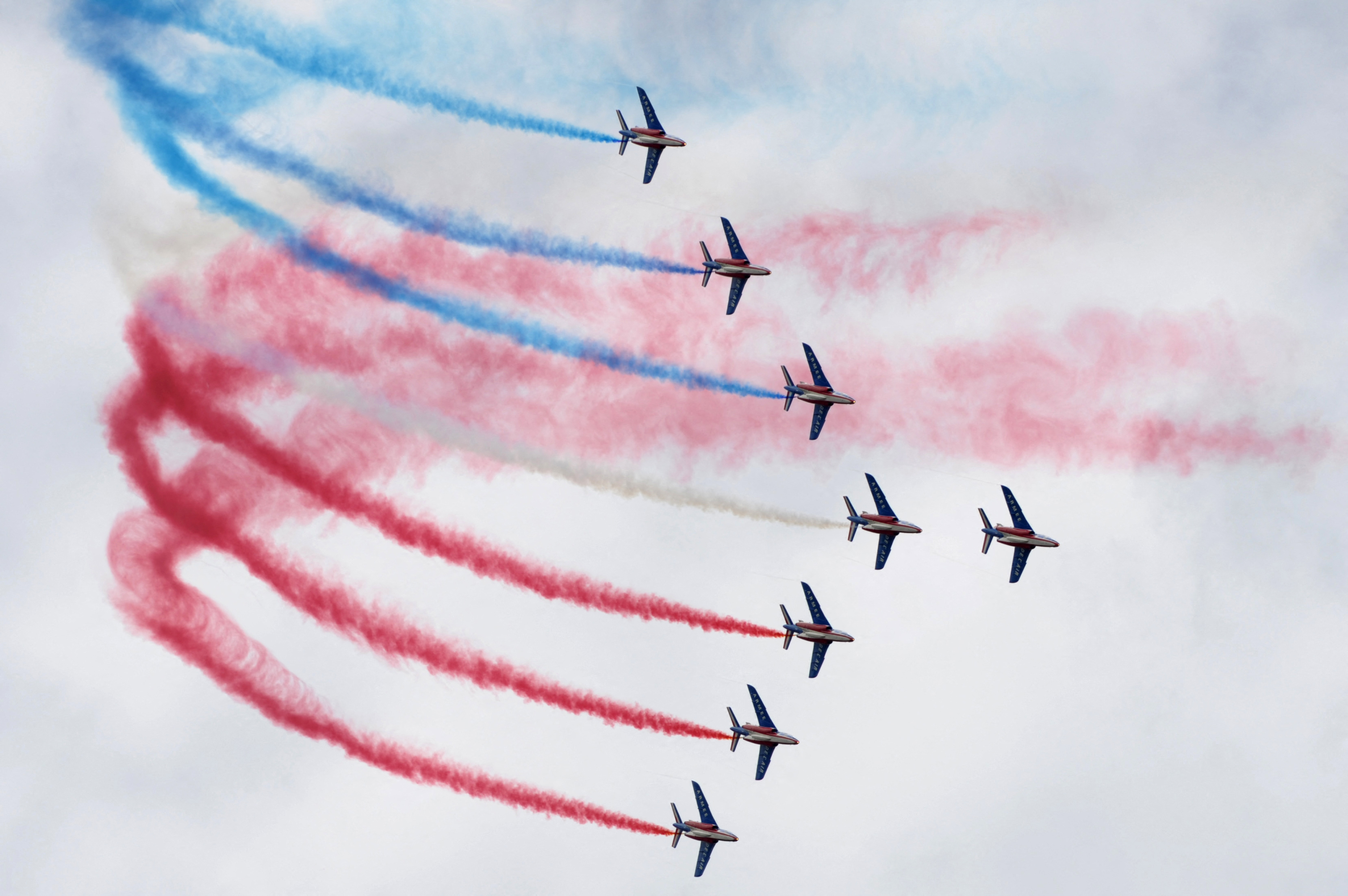 Planes release smoke in the colors of the French flag