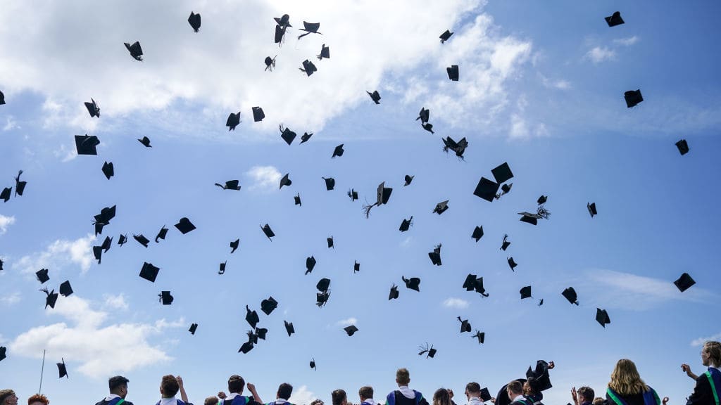 Flying graduation caps.