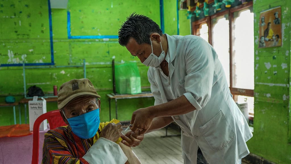 A man in Bhutan receives a COVID-19 vaccine.
