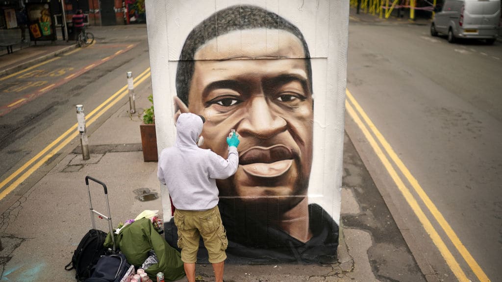 A British artist creates a mural of George Floyd.