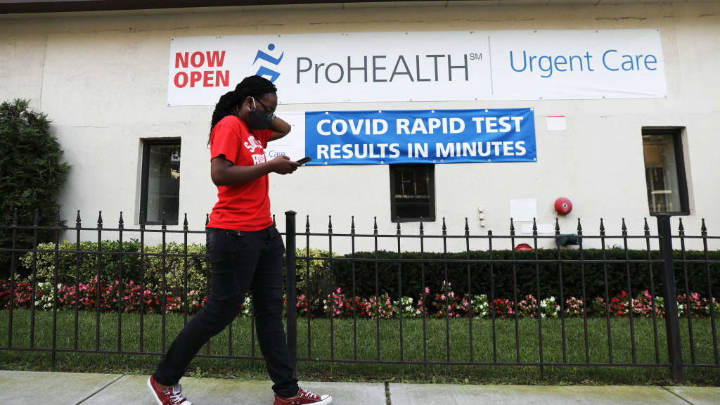 A person walks by a COVID-19 rapid testing center.