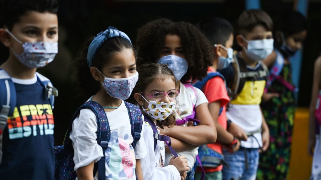Elementary school students wearing masks.