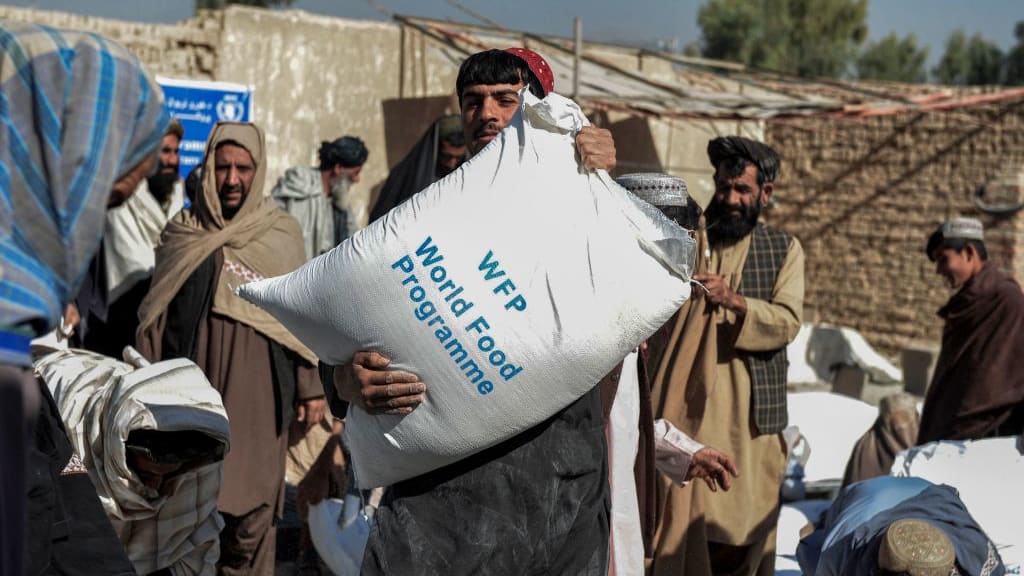 A man receives food aid in Afghanistan.
