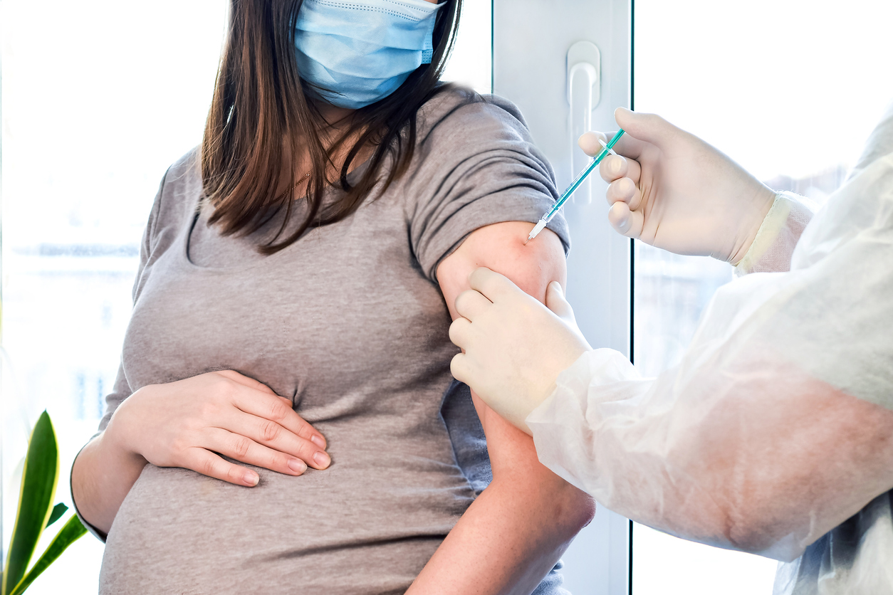 Pregnant person receiving COVID-19 vaccine.