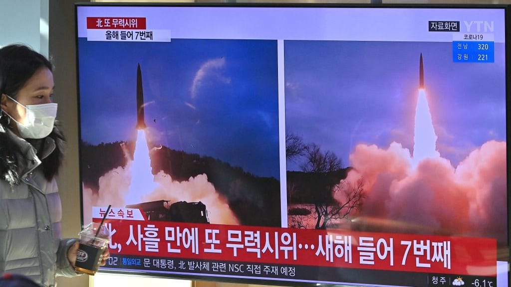 A woman watches video of a North Korean missile launch.