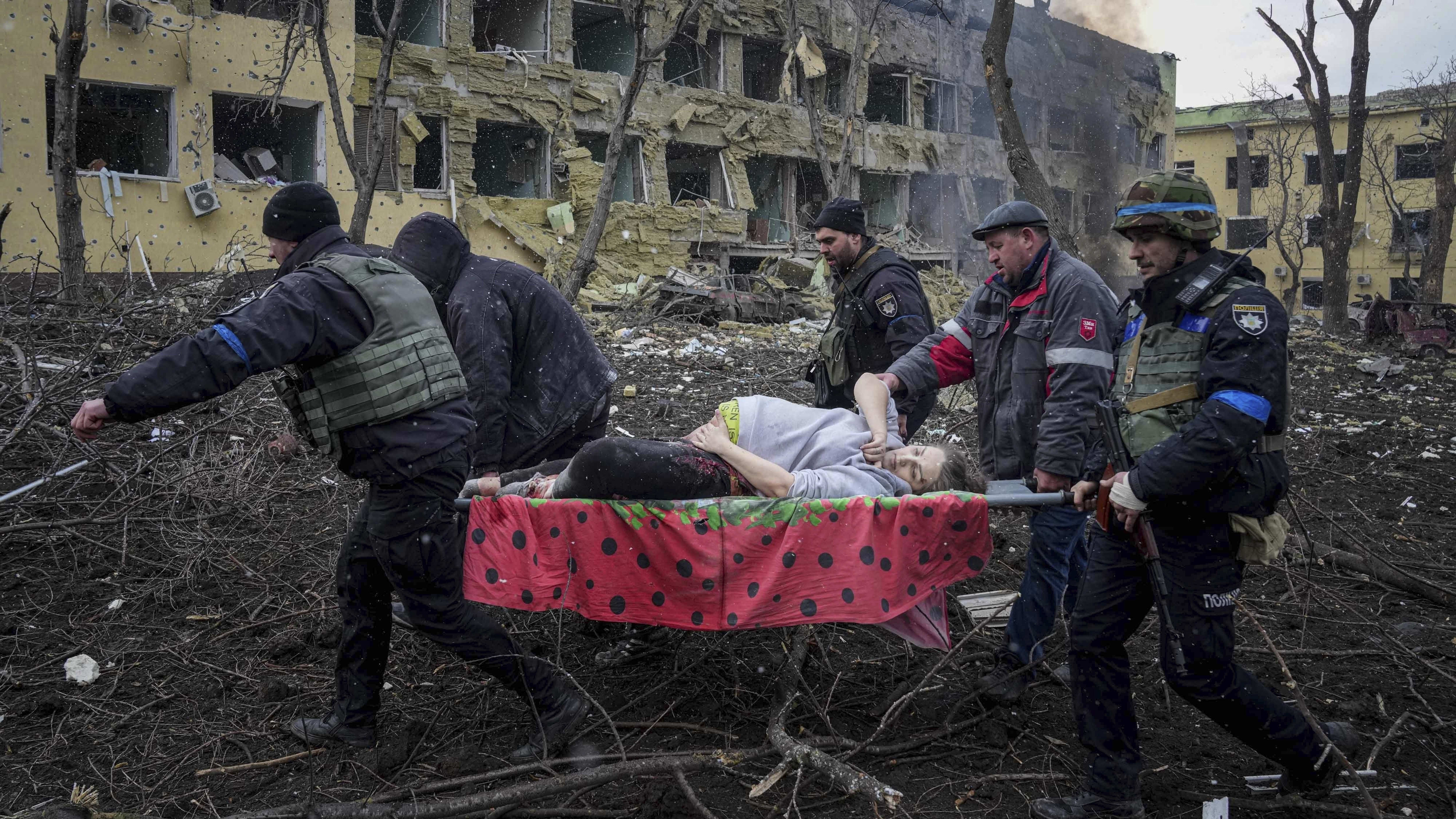 A pregnant woman is evacuated from a maternity hospital that was shelled Wednesday in Ukraine.