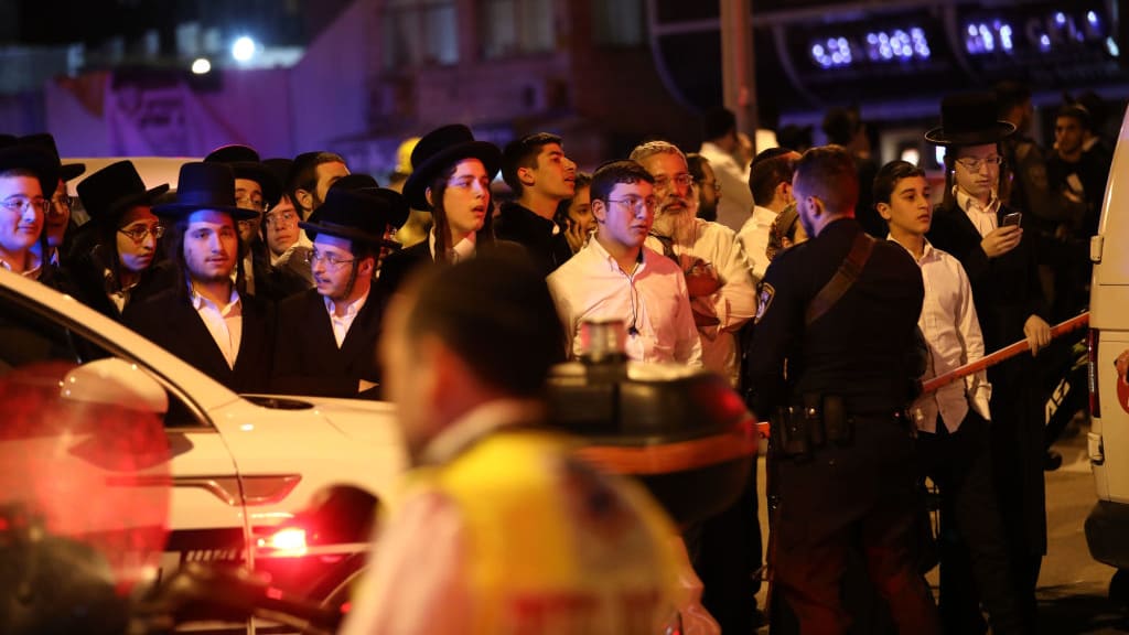 Residents gather near the site of a shooting in Bnei Brak, Israel.