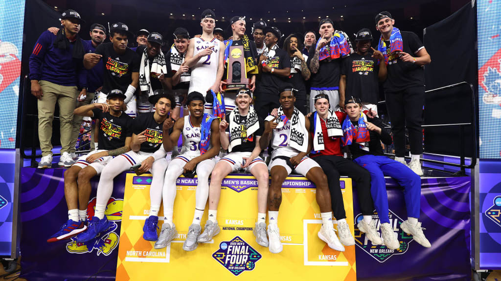 The Kansas Jayhawks pose for a photo after winning the 2022 NCAA men&#039;s basketball tournament.
