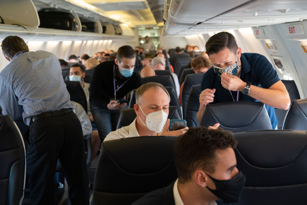 Passengers wear masks on a plane