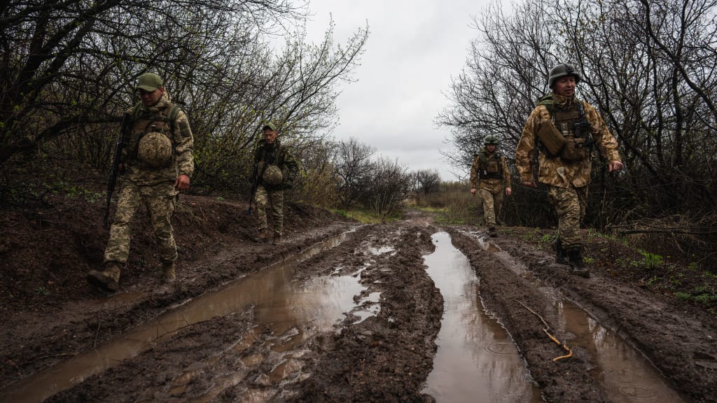 Ukrainian troops on a muddy road in the Donbas region.