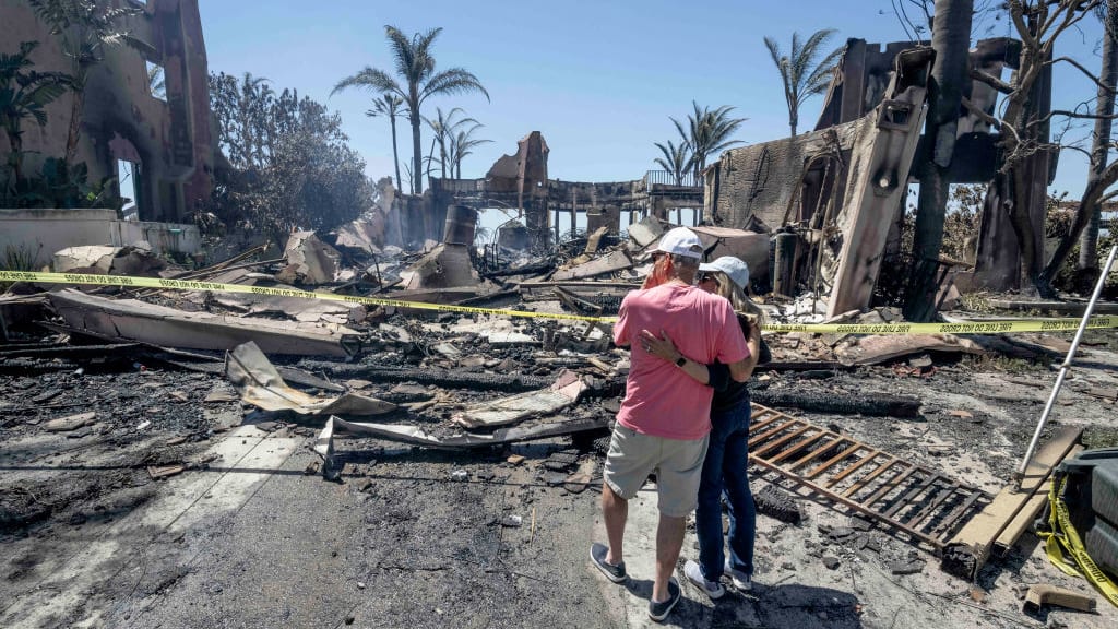 Richard and Sandy Vogel in front of their destroyed home in Laguna Niguel, California.
