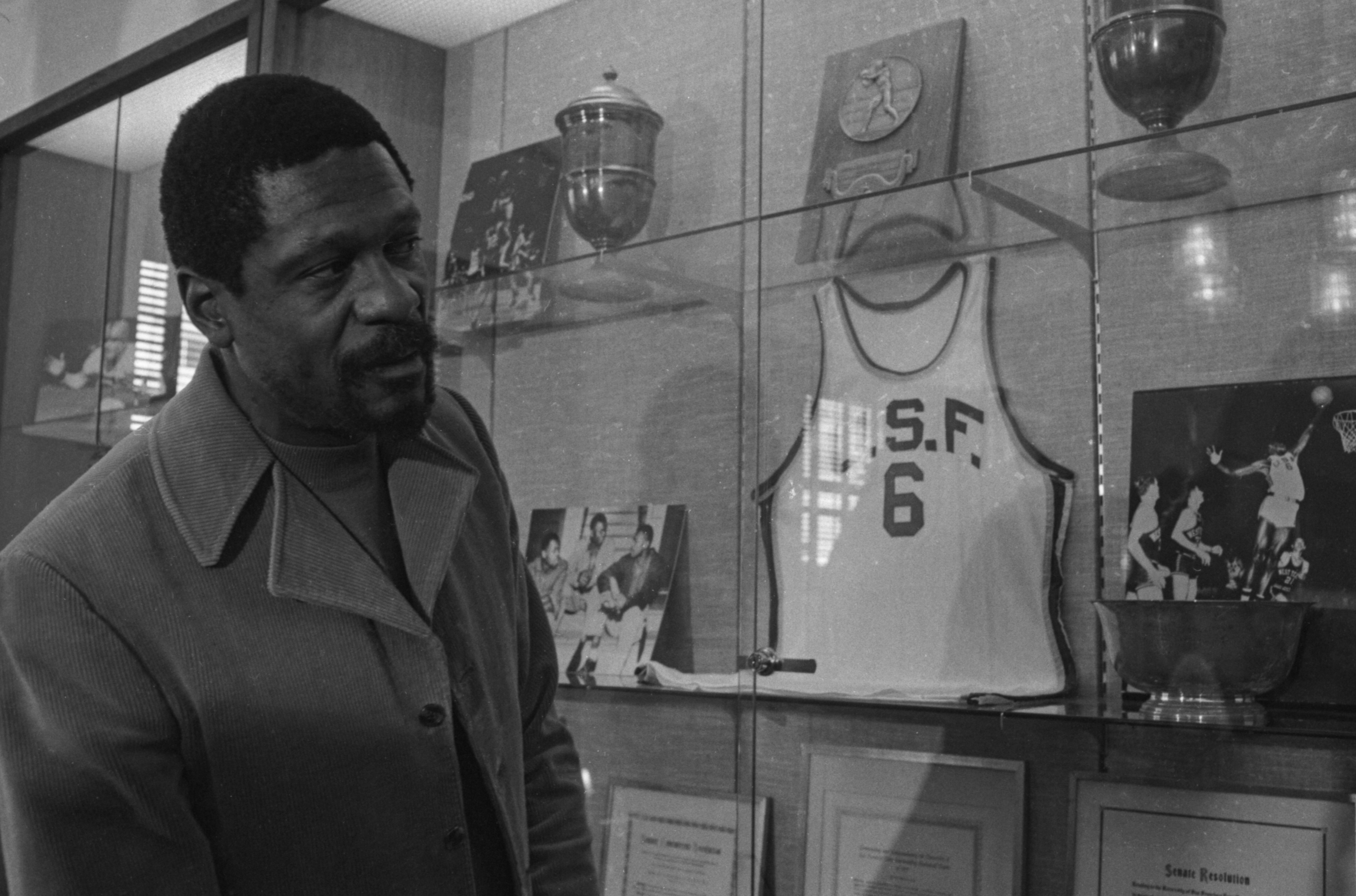 Bill Russell stands next to an old jersey 