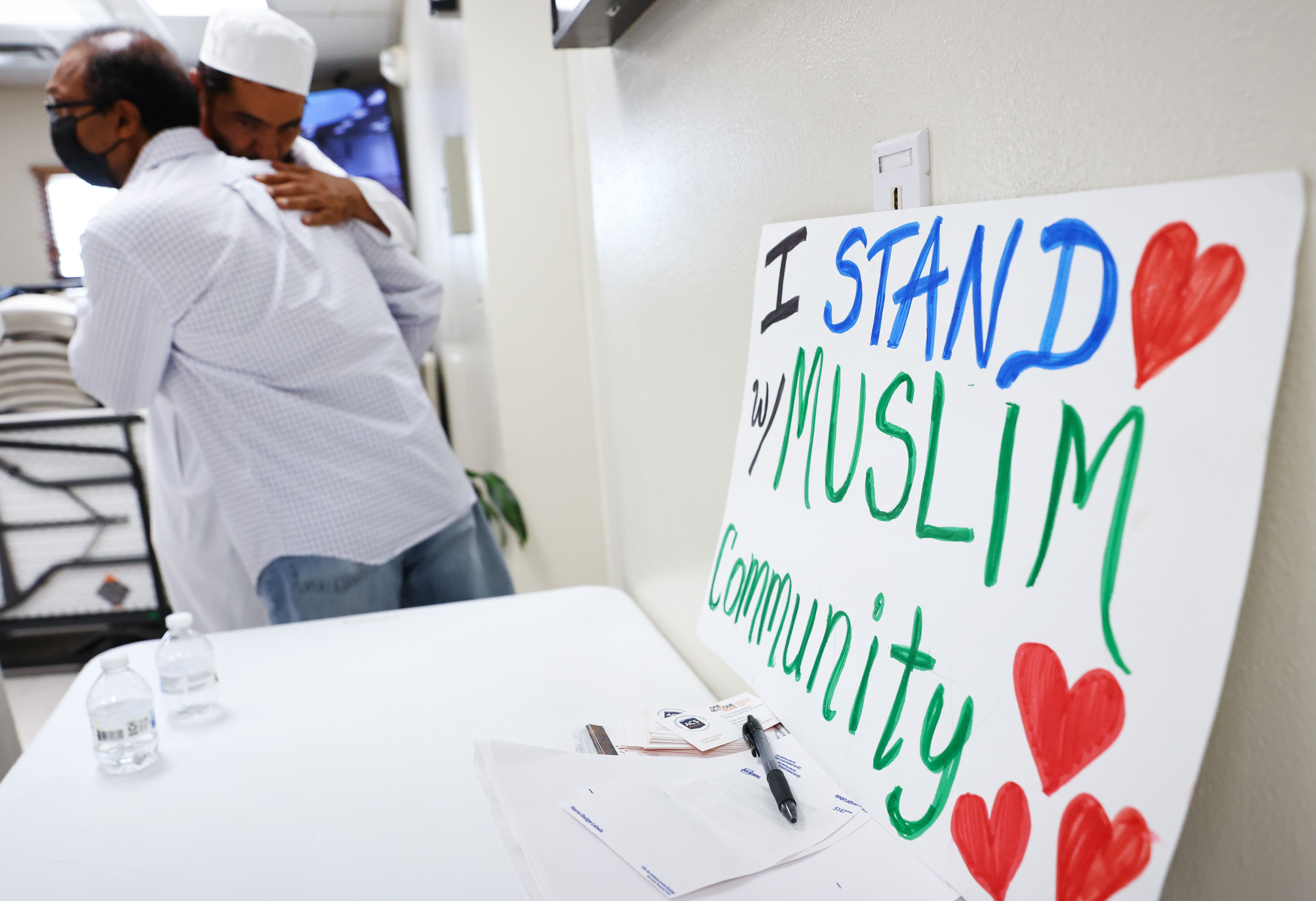 Muslims embrace following Friday prayers at the Islamic Center of New Mexico on August 12, 2022
