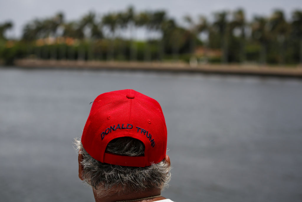 Man wearing a Trump hat nearby Mar-a-Lago.