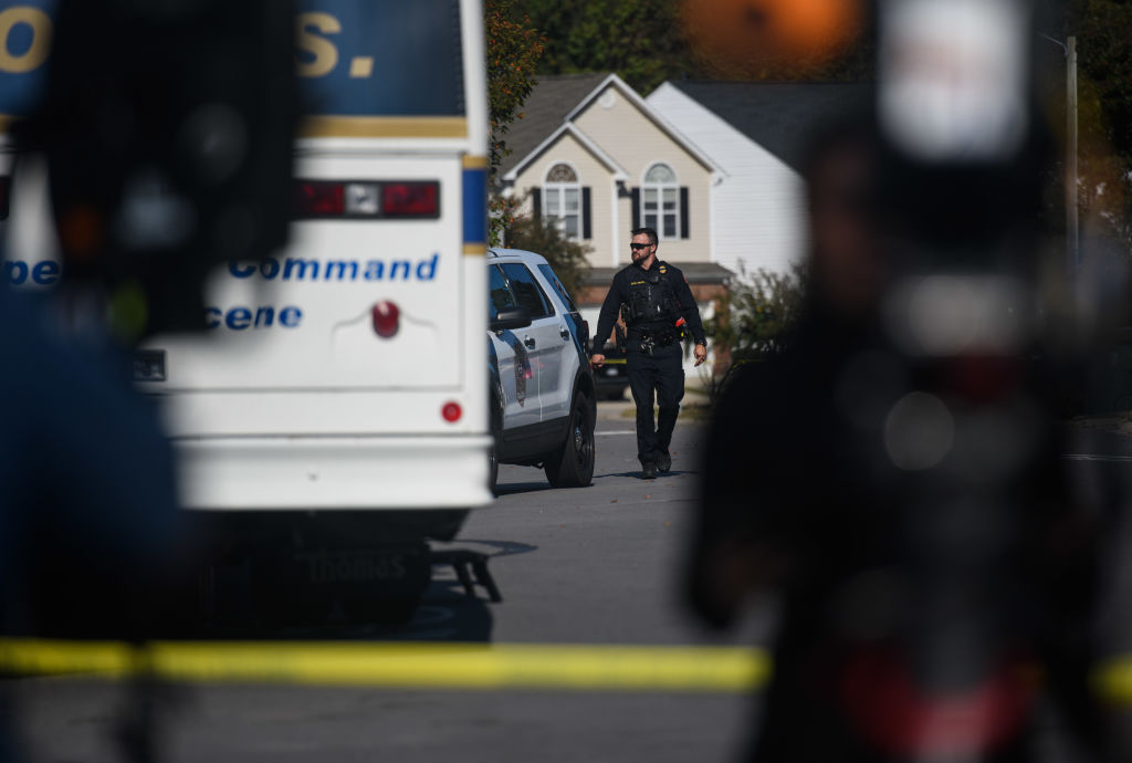 Cop walking in Raleigh crime scene