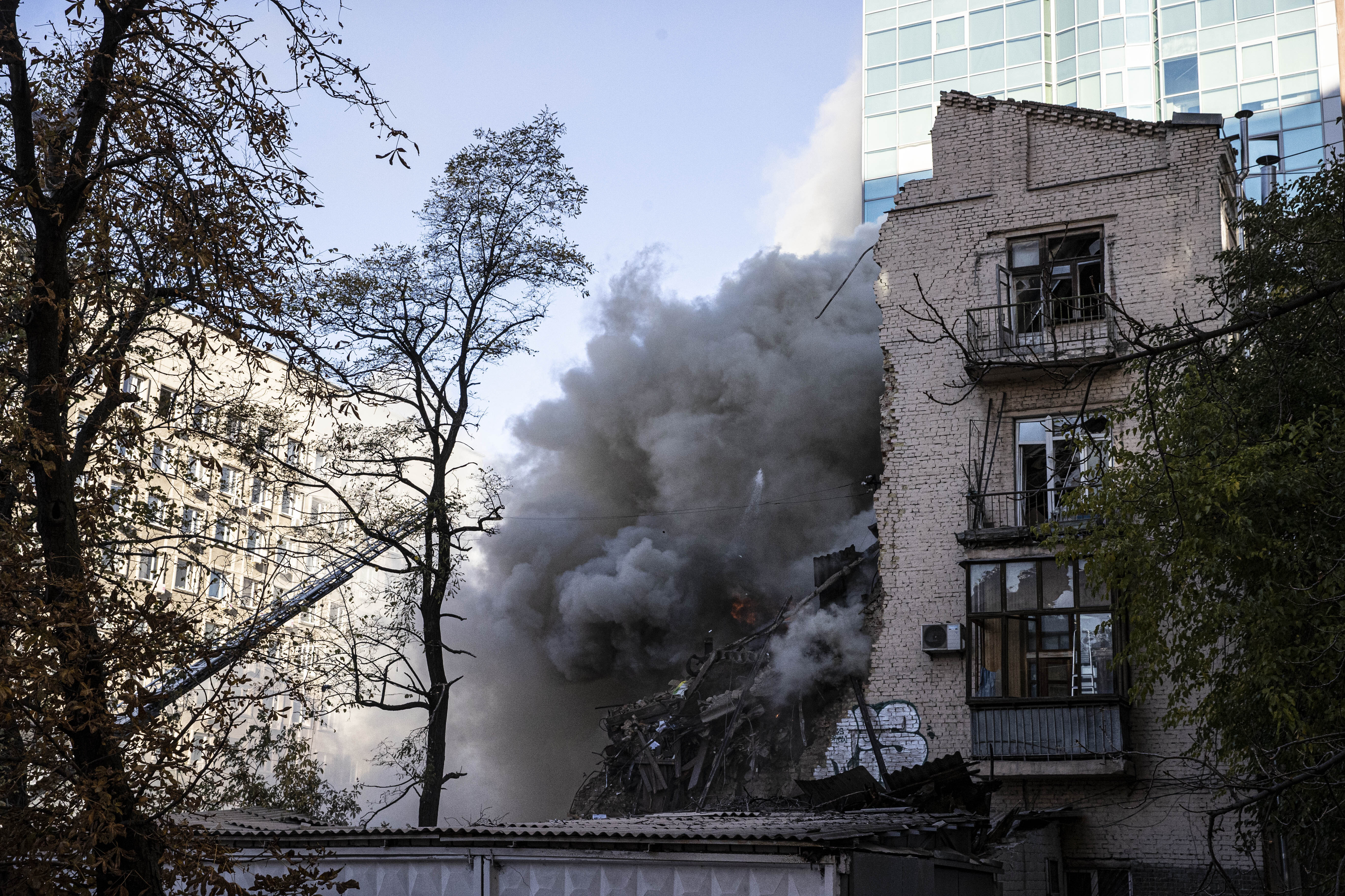 Smoke rises from a Ukrainian building hit by a Russian drone strike. 