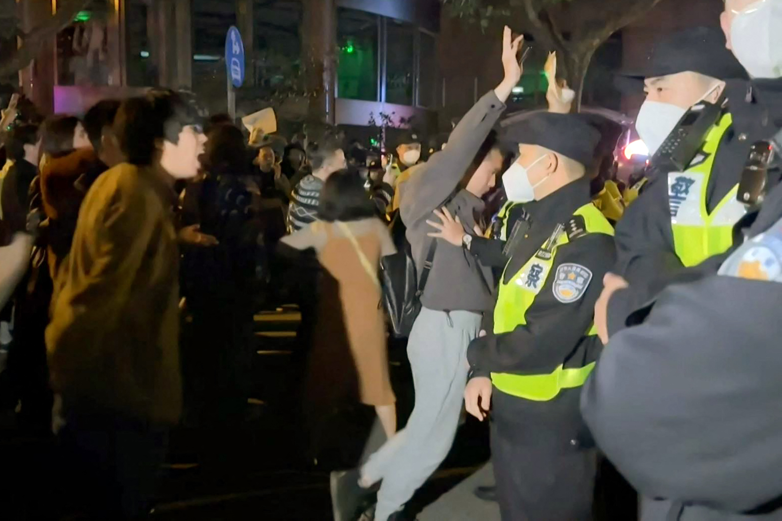 Chinese protesters are seen clashing with police in Shanghai. 