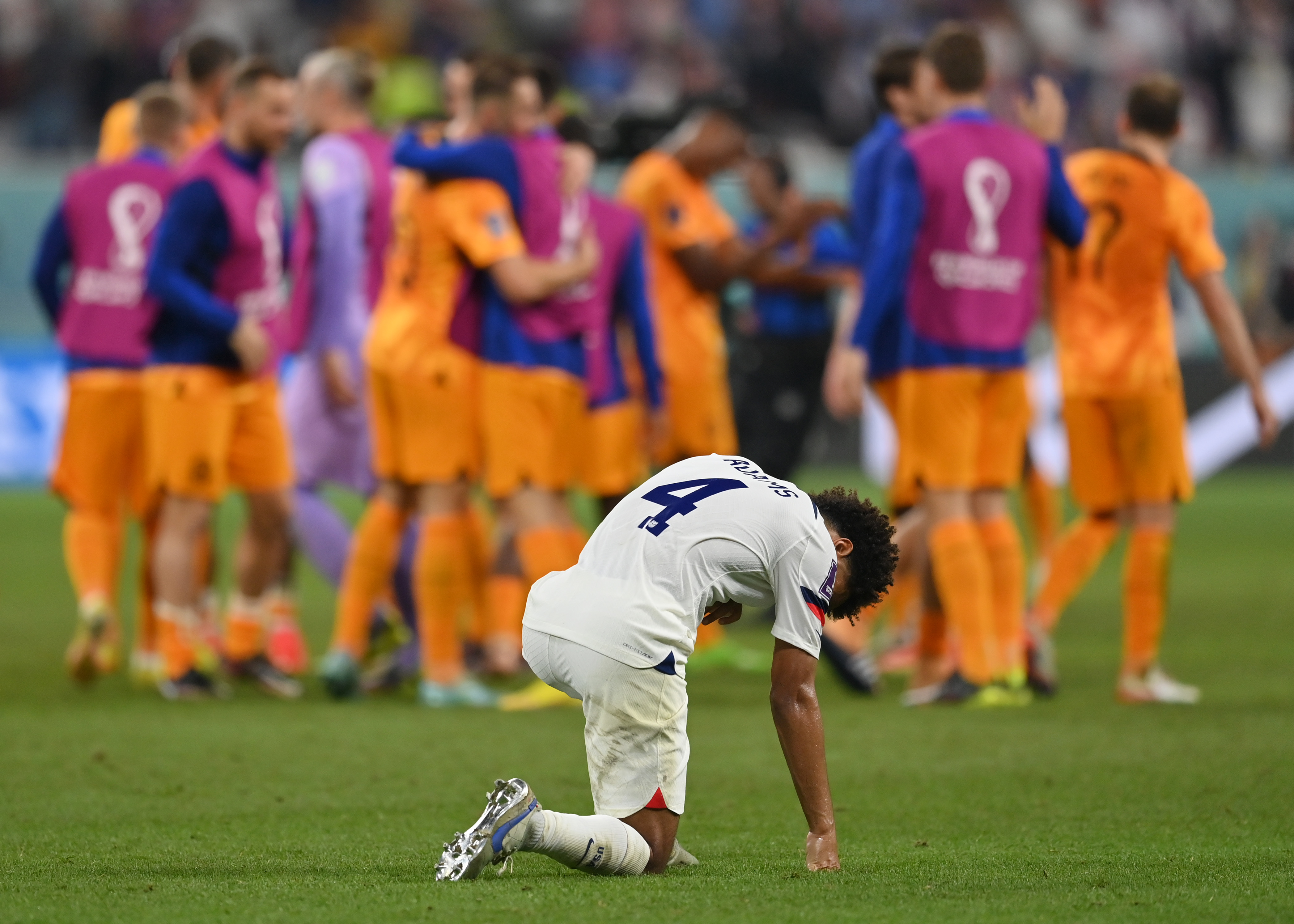 U.S. captain Tyler Adams kneels after his team is eliminated in the World Cup. 