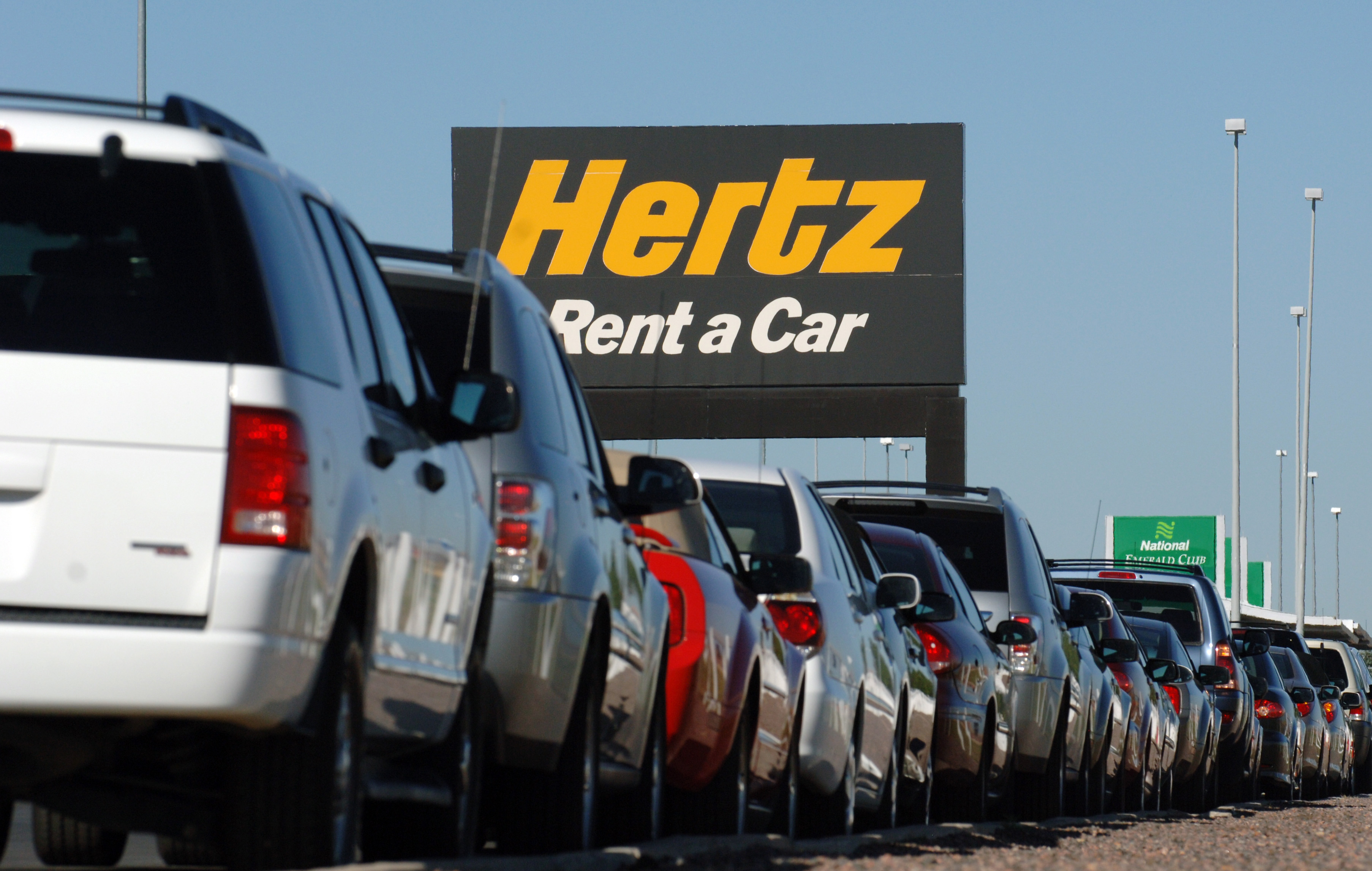A view of a Hertz Rent-a-Car parking lot. 