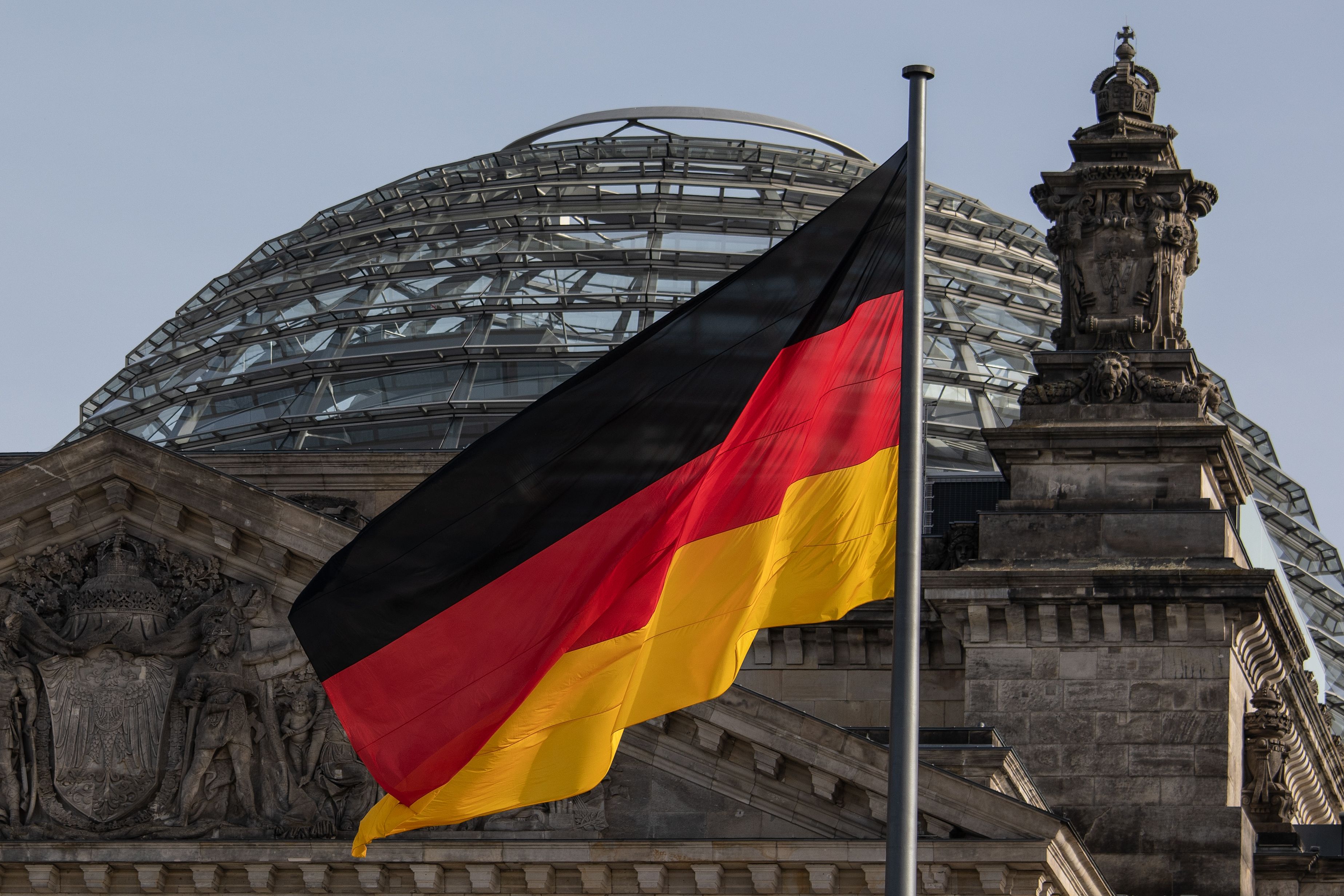 German flag flies in front of the Reichstag, the German Parliament building. 