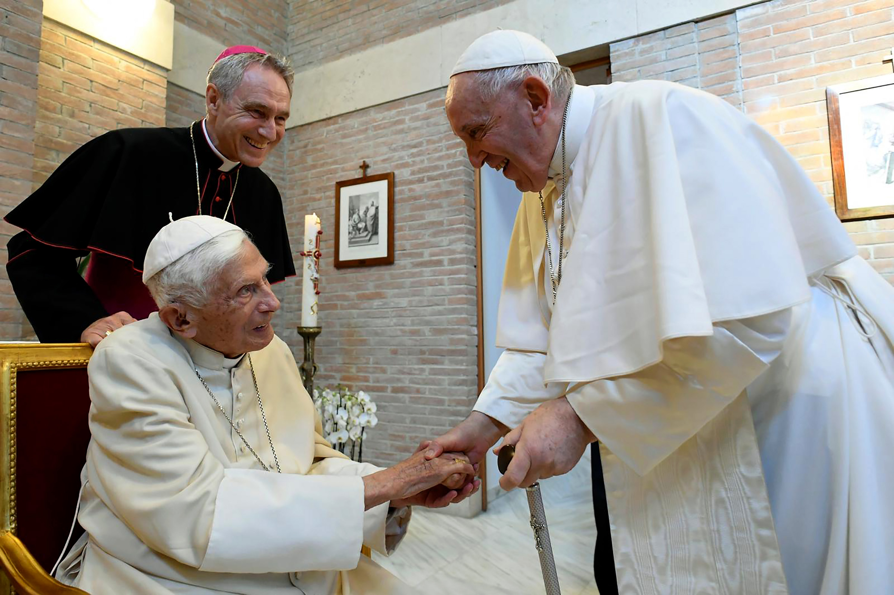 Pope Francis and Pope Benedict greet each other in August 2022