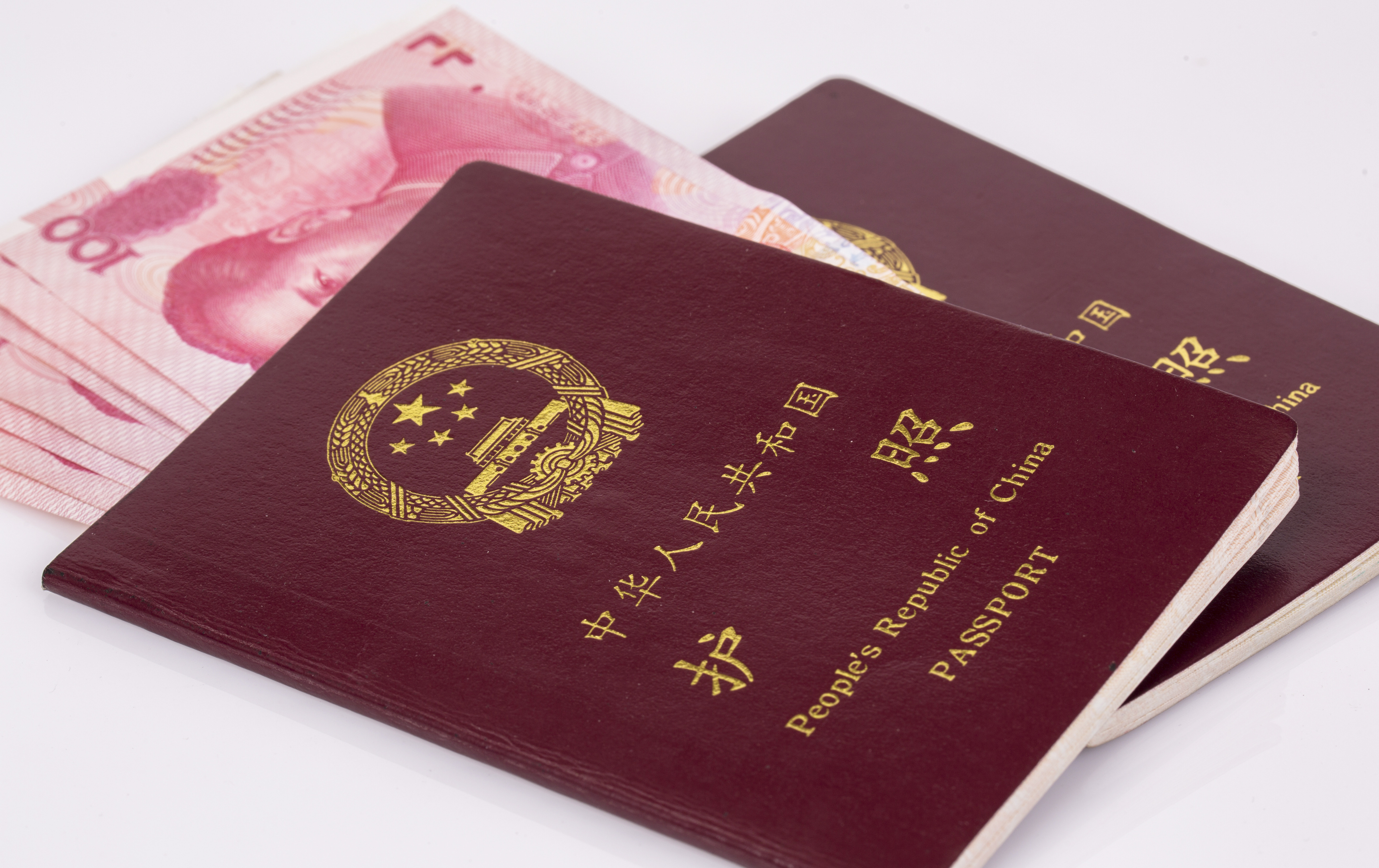A Chinese passport and banknotes are seen. 