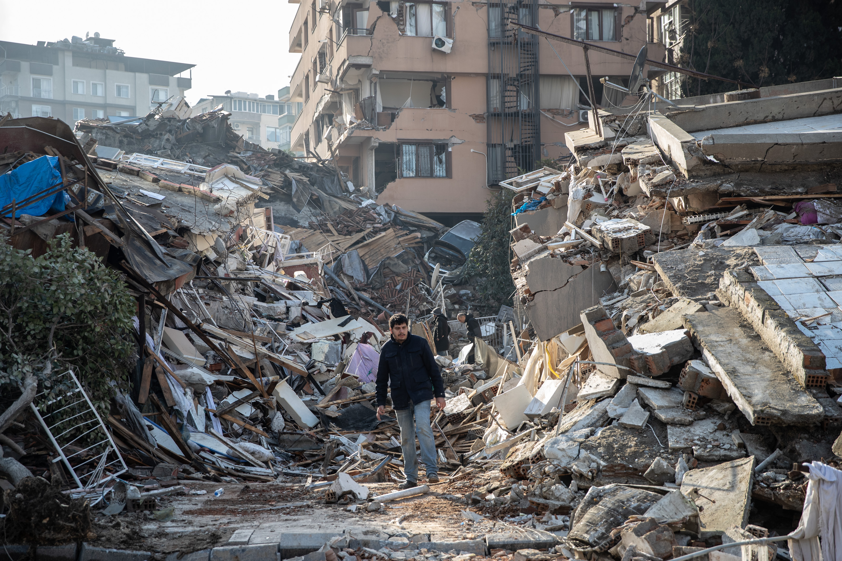 A man walks through the rubble following an earthquake in Turkey. 