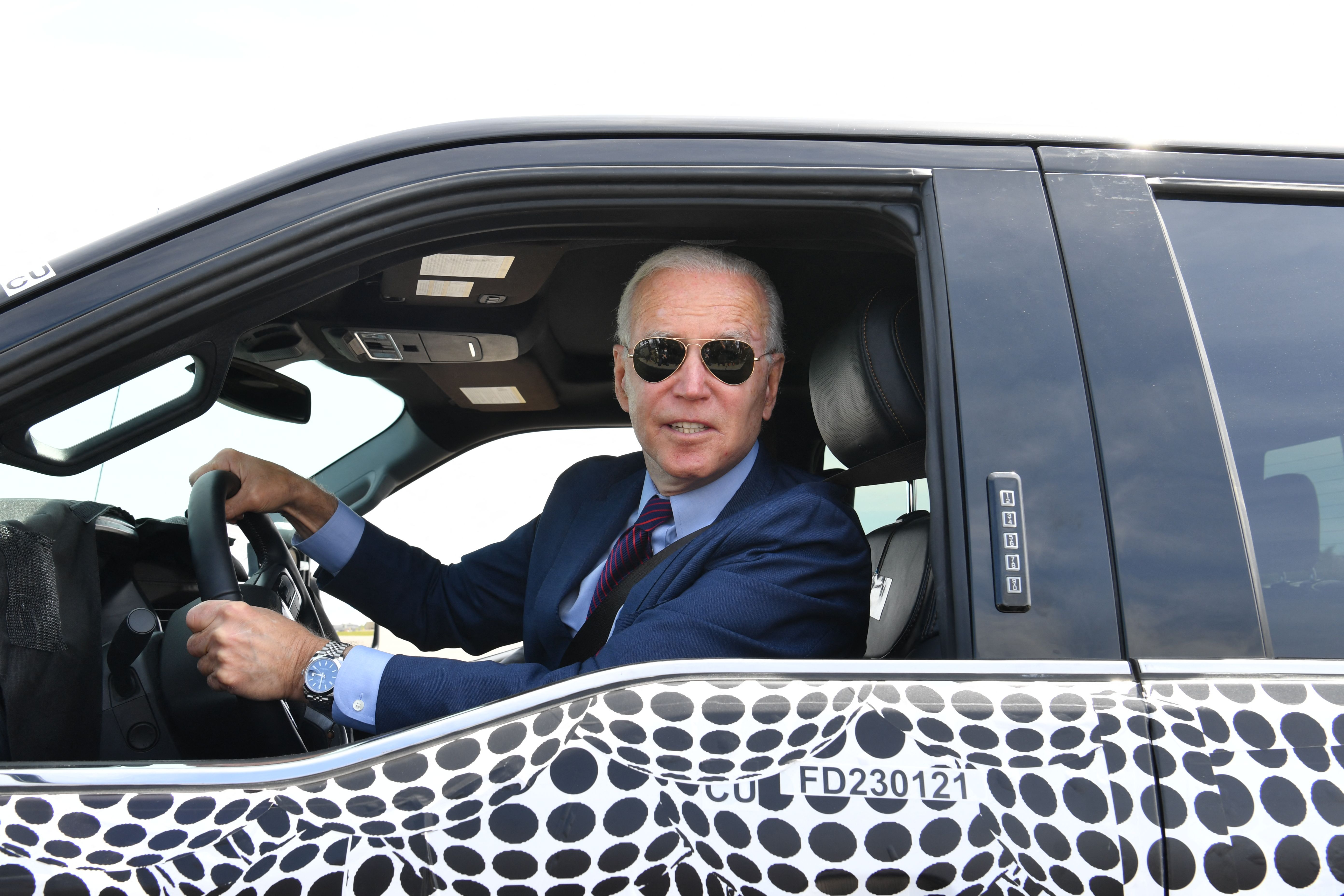 Biden driving an electric Ford F-150 Lightning in May 