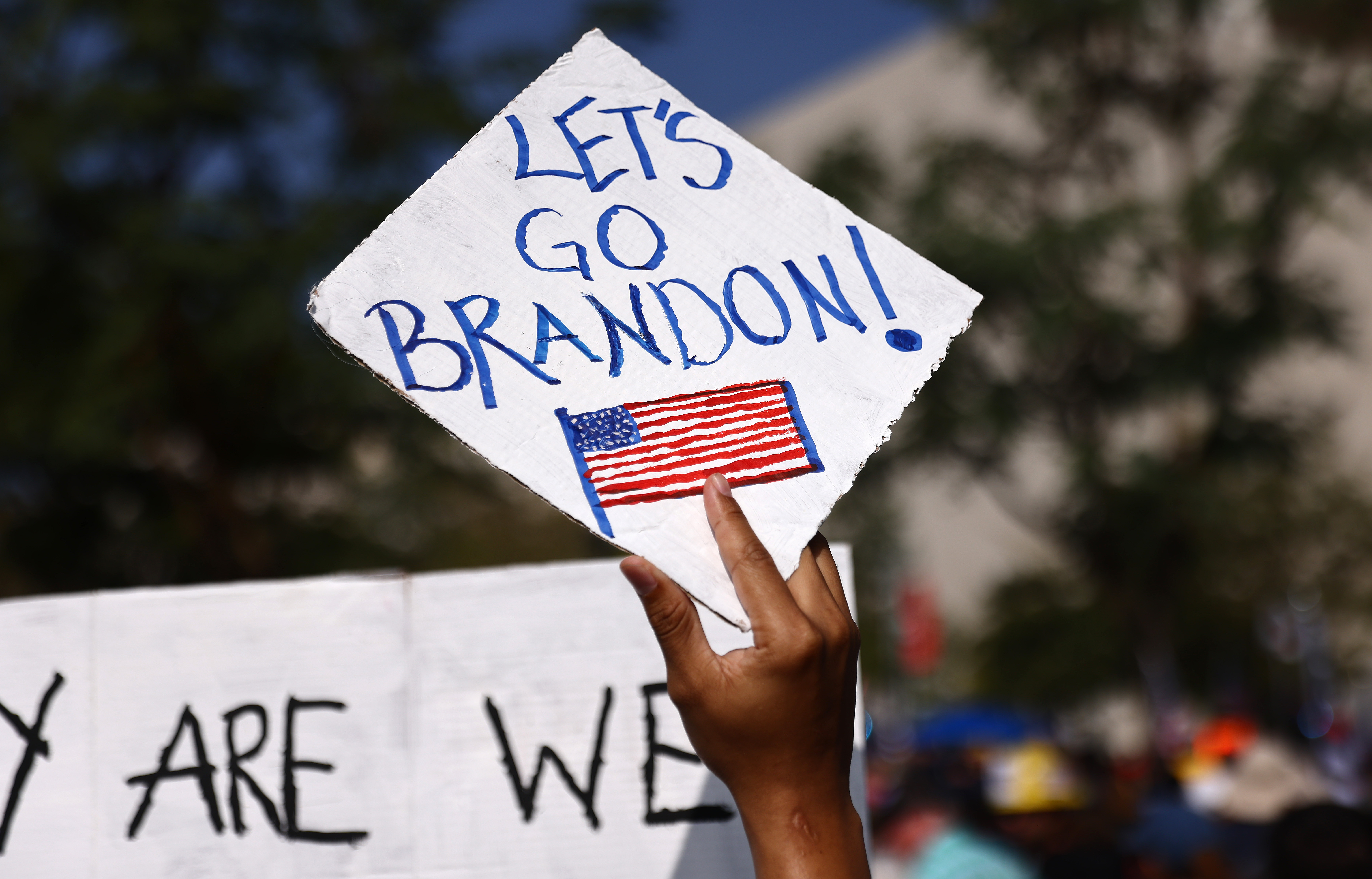 A protestor holds a &#039;Let&#039;s Go Brandon!&#039; sign in Los Angeles