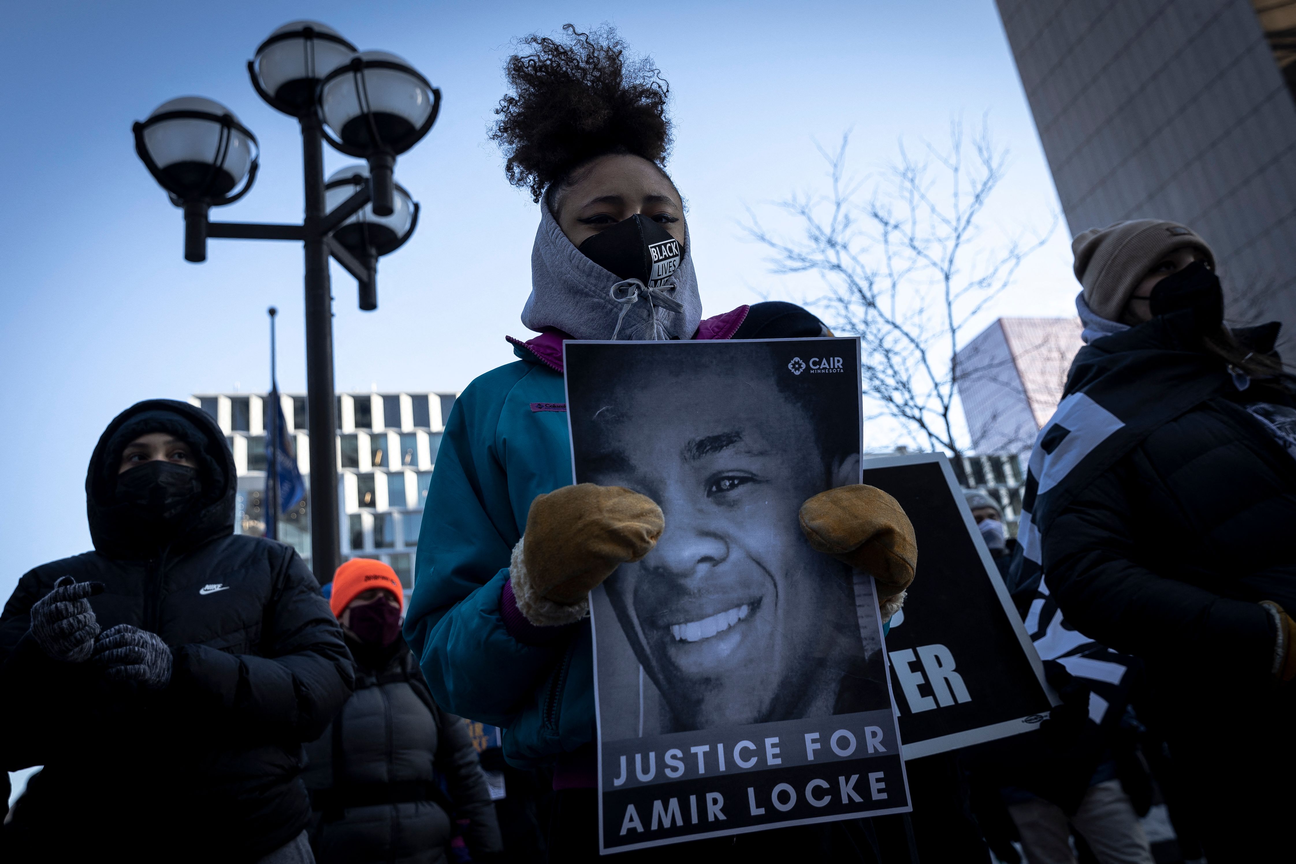 A demonstrator holds a photo of Amir Locke on Feb. 5, 2022