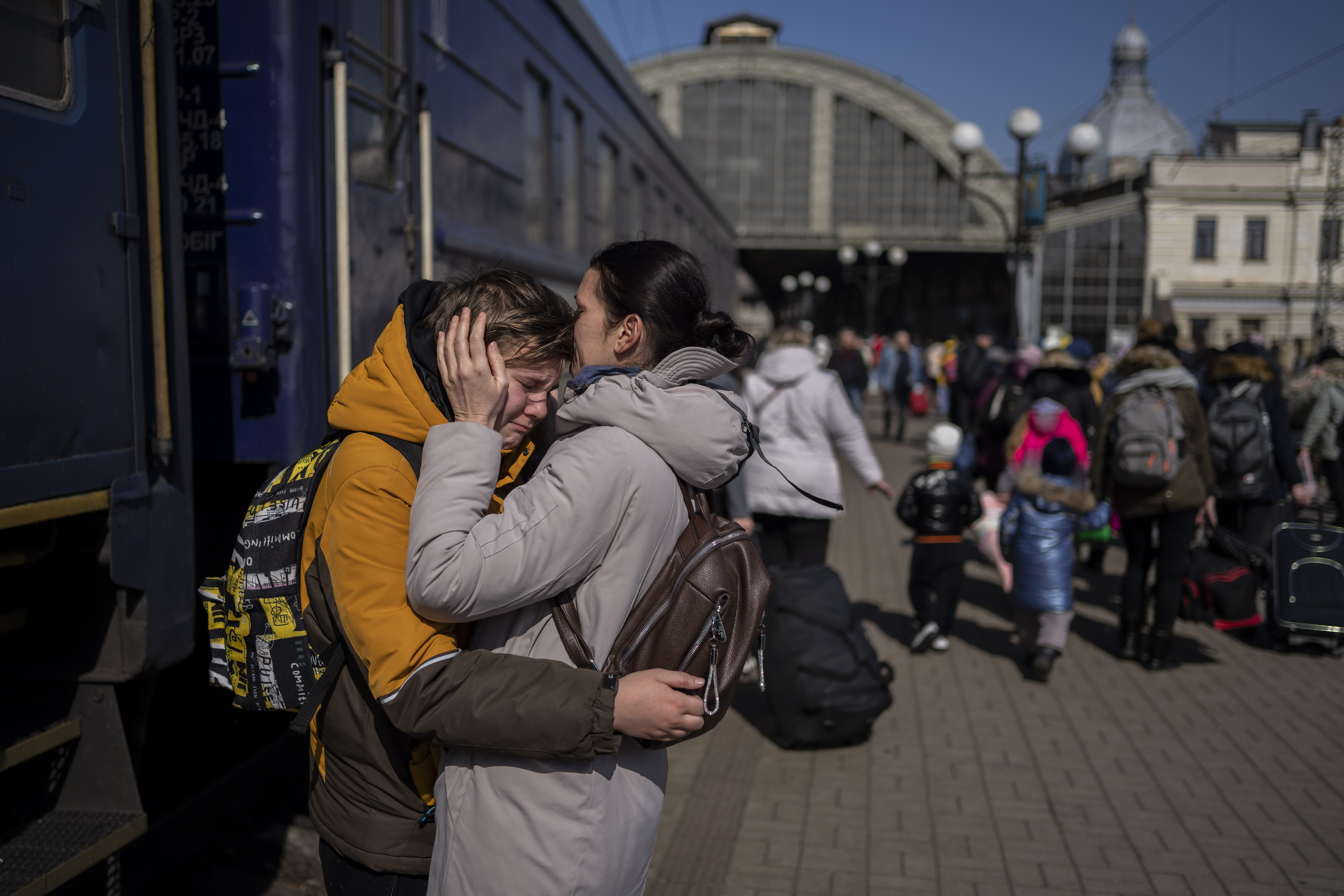 A mother hugs her son, who escaped Mariupol, at the Lviv train station