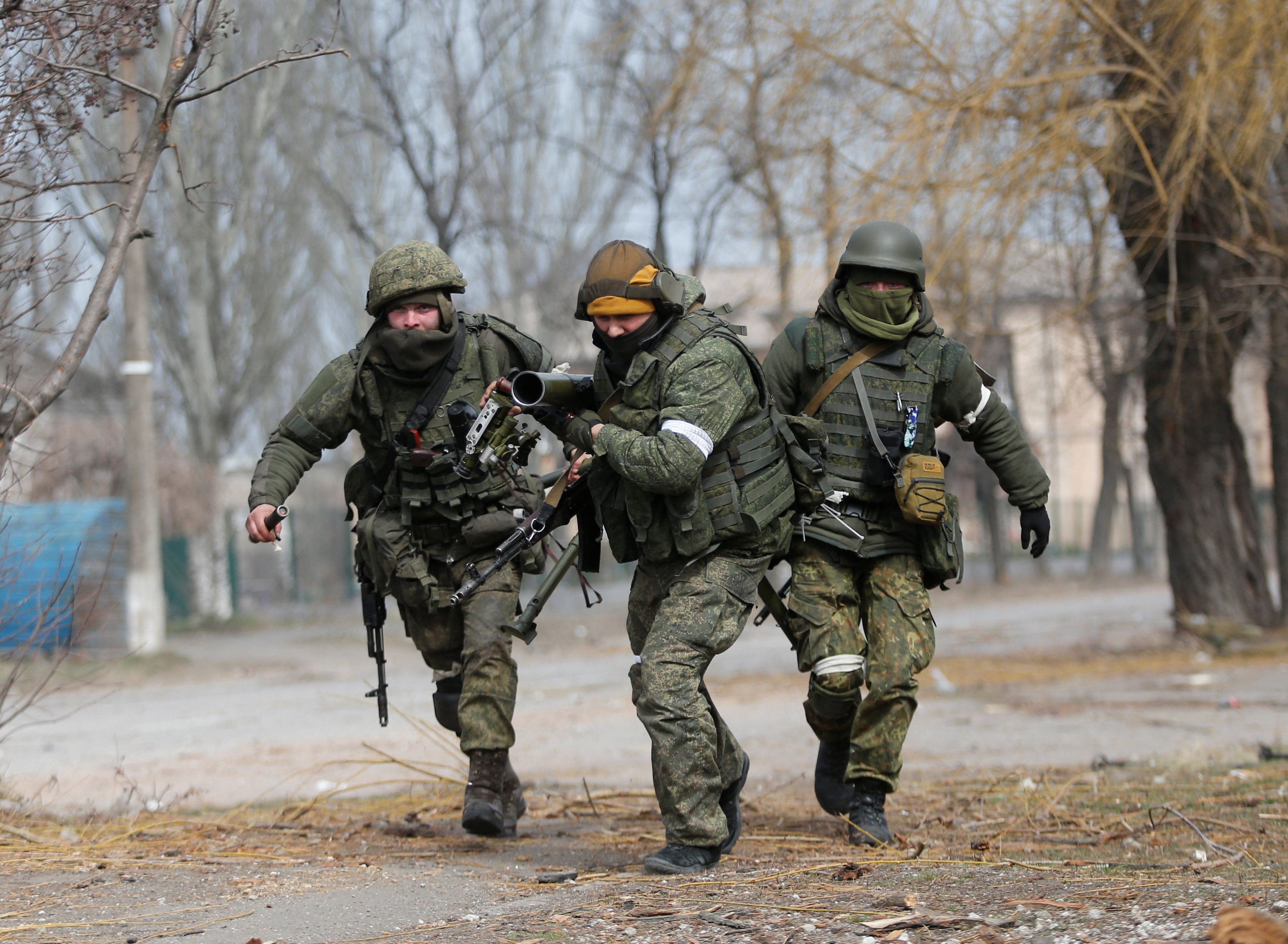 Pro-Russian troops carry an anti-tank grenade launcher in Mariupol