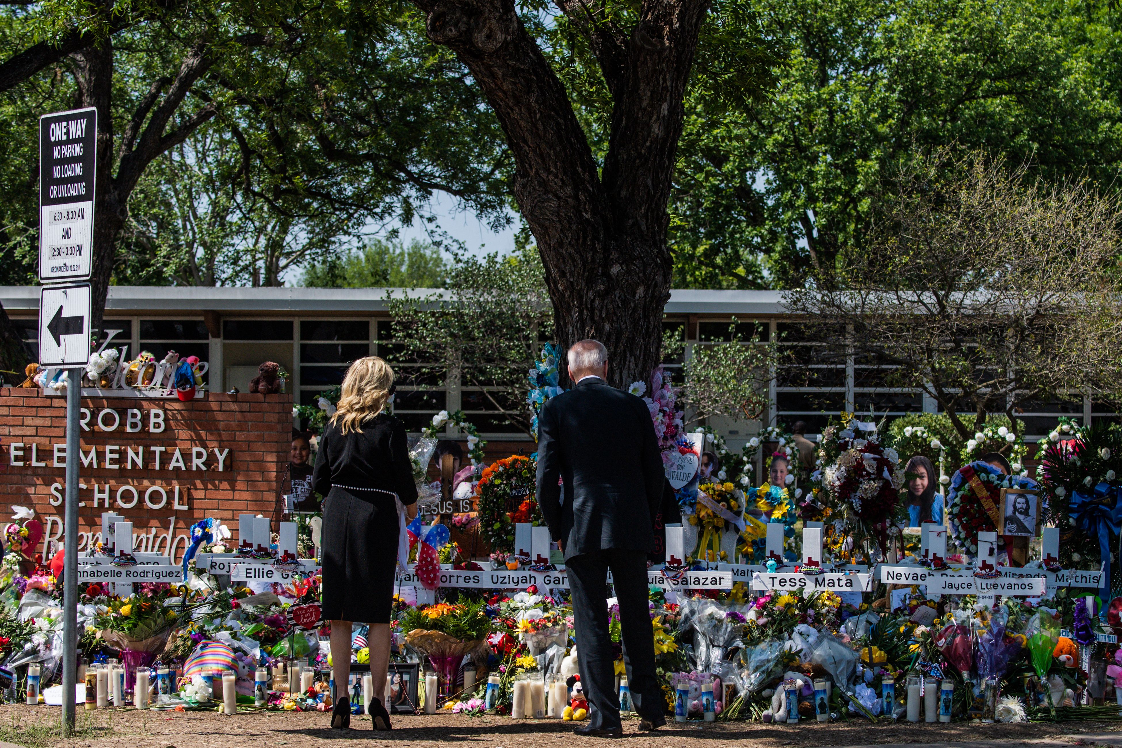 Joe Biden and first lady Jill Biden visit a memorial outside Robb Elementary School