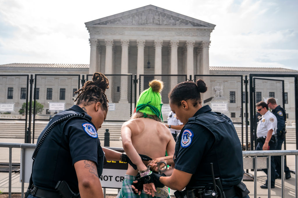 Topless protester arrested outside Supreme Court