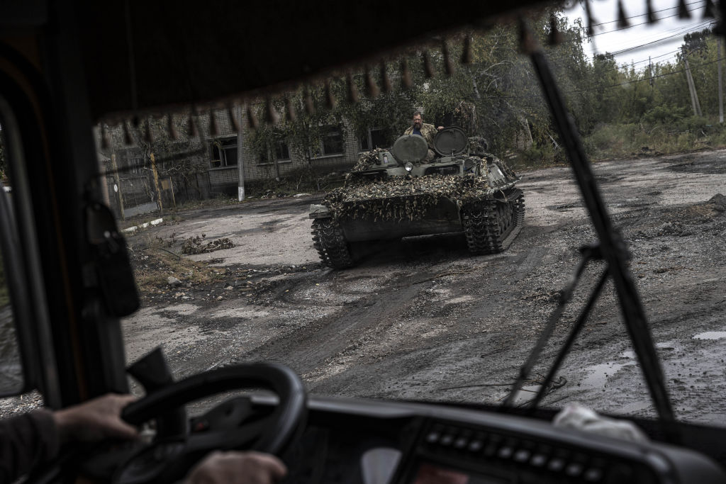 Ukrainians in tanks after Russians flee