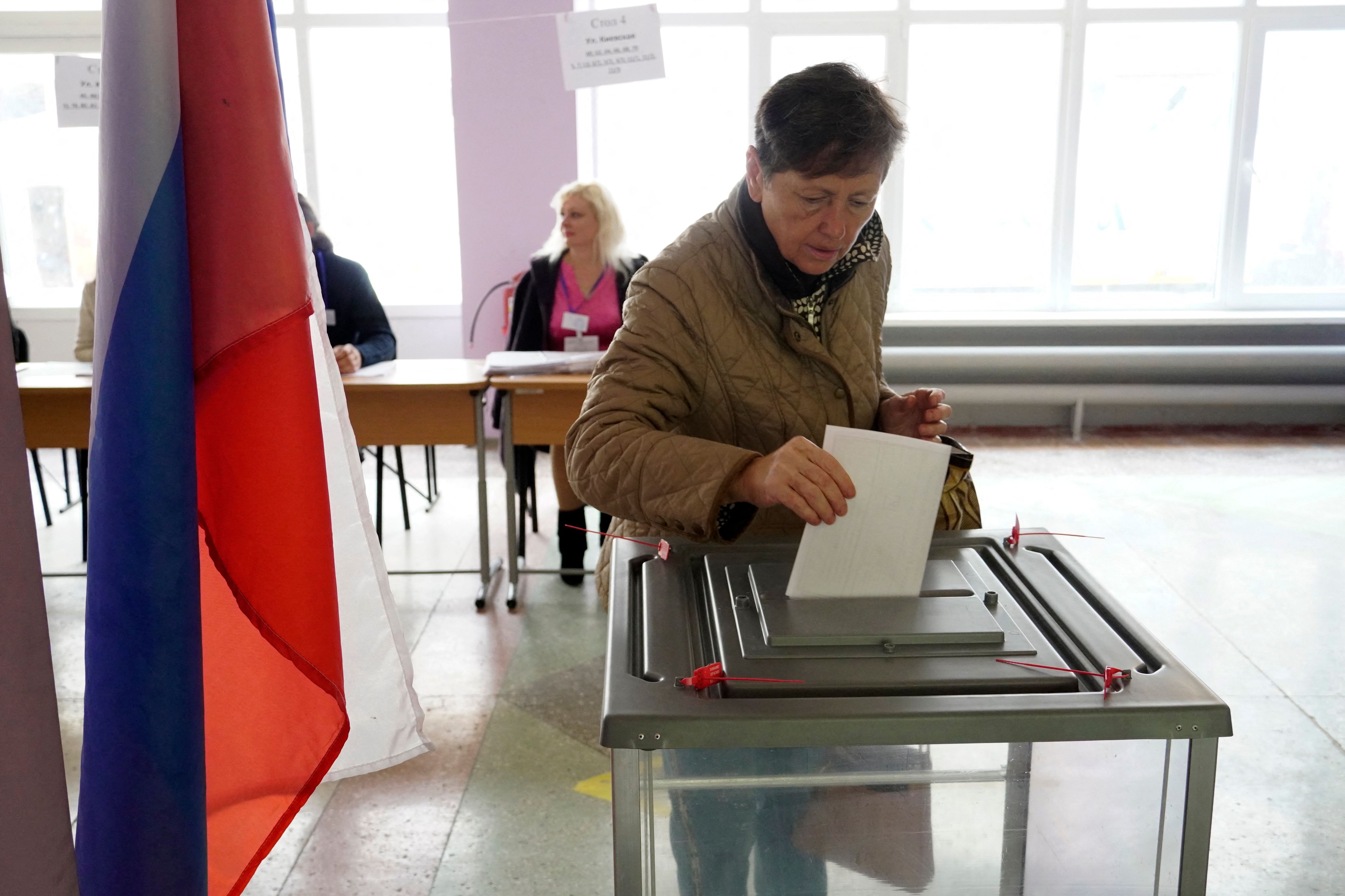 A woman casts her ballot in Mariupol
