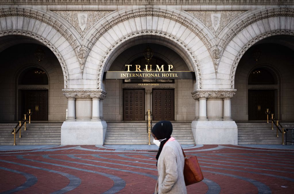 Woman walks in front of the Trump International Hotel in Washington, D.C.