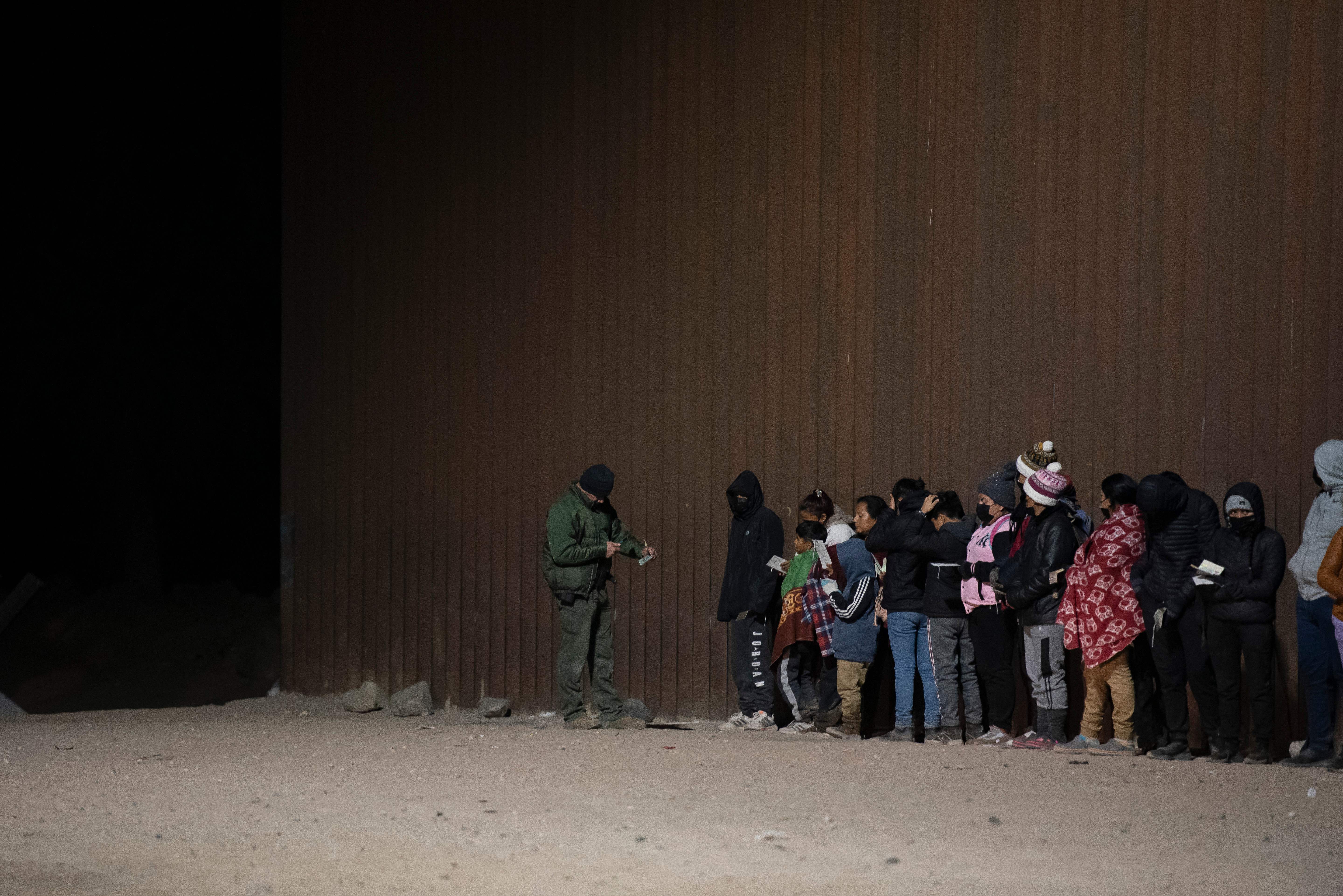 A Border Patrol agent processes asylum seekers