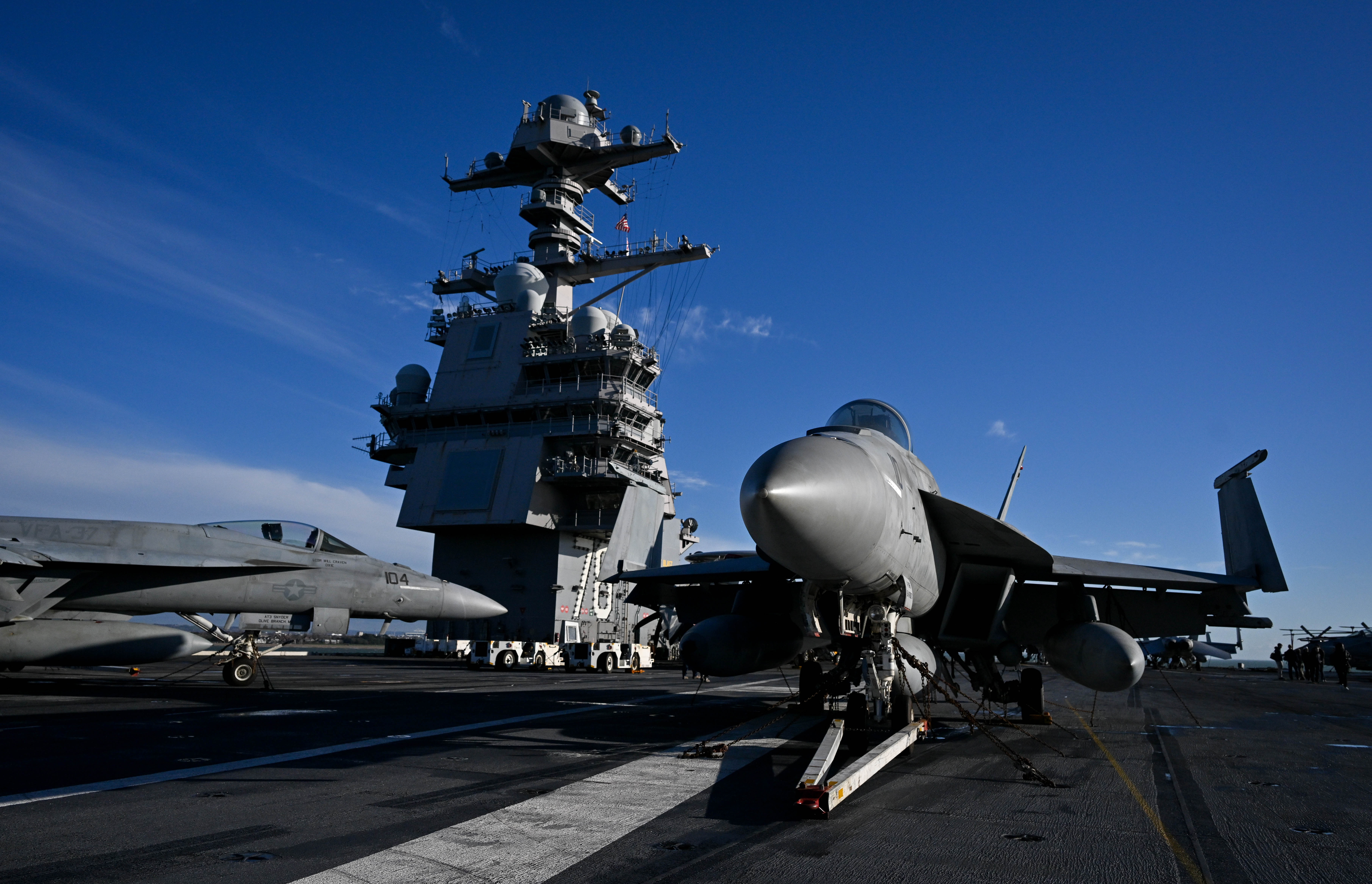 A U.S. Navy fighter on the deck of an aircraft carrier. 