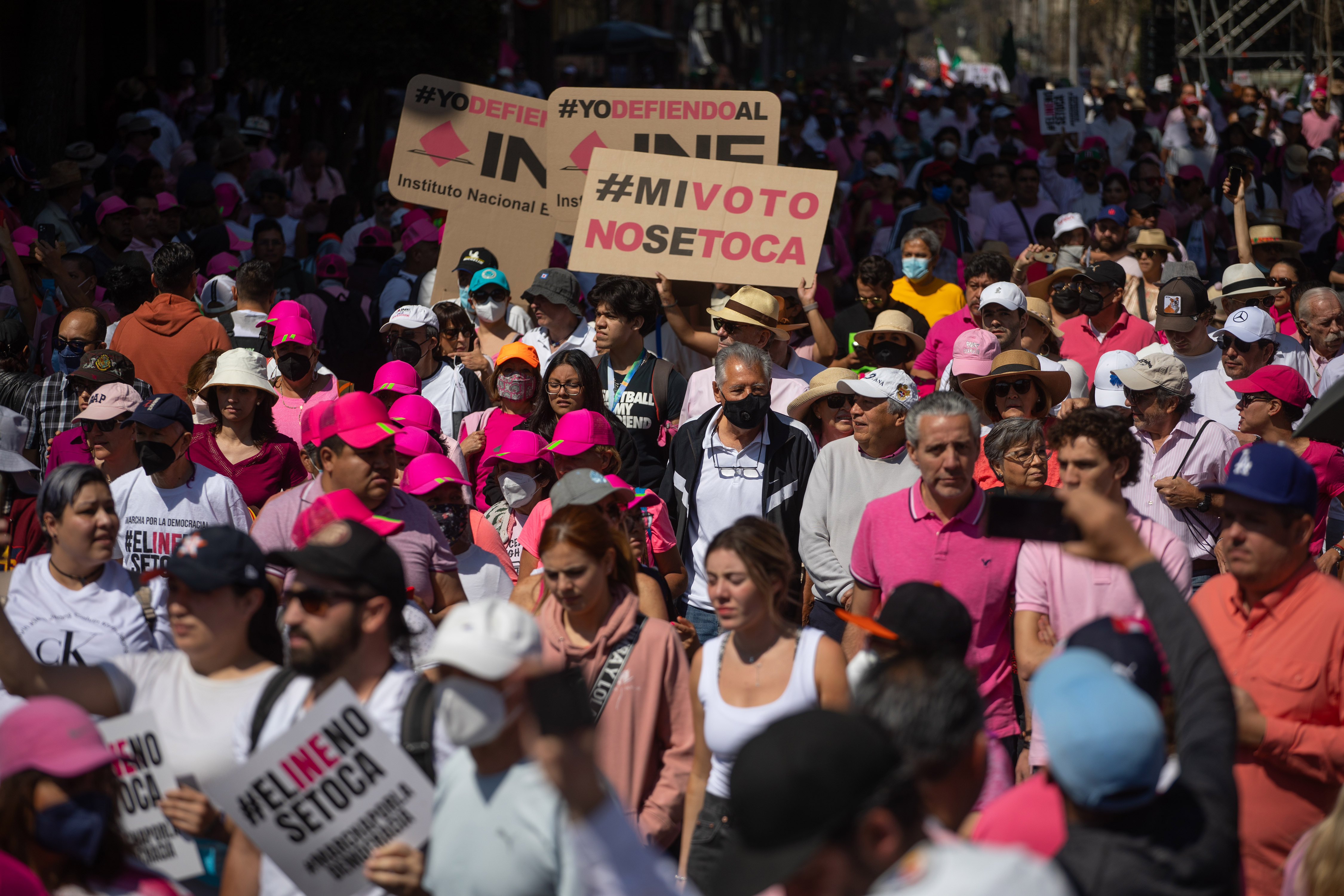 Crowd of protestors wearing pink and white at the Zocalo main square, in Mexico City, Mexico 