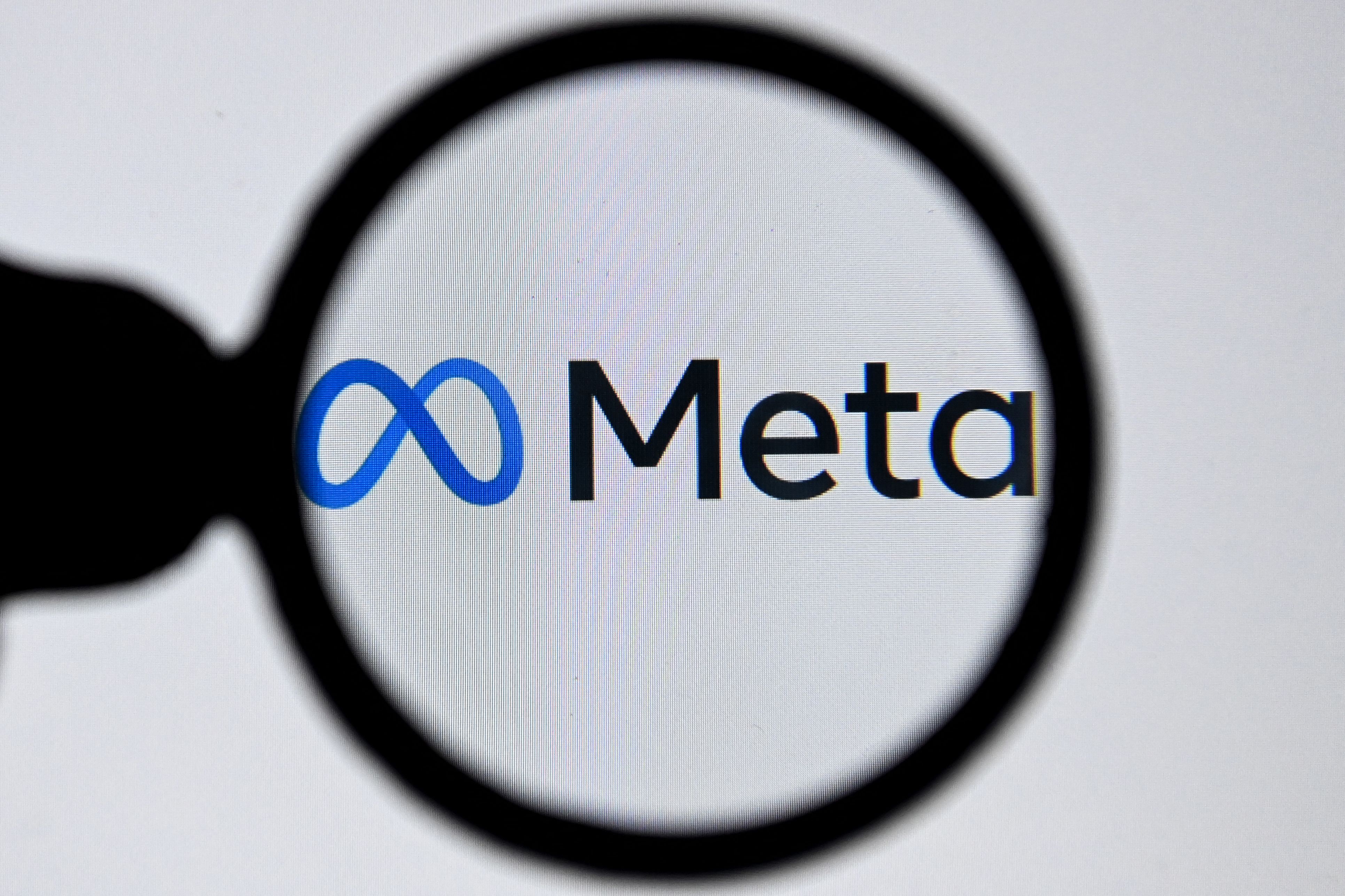 The Meta logo under a magnifying glass