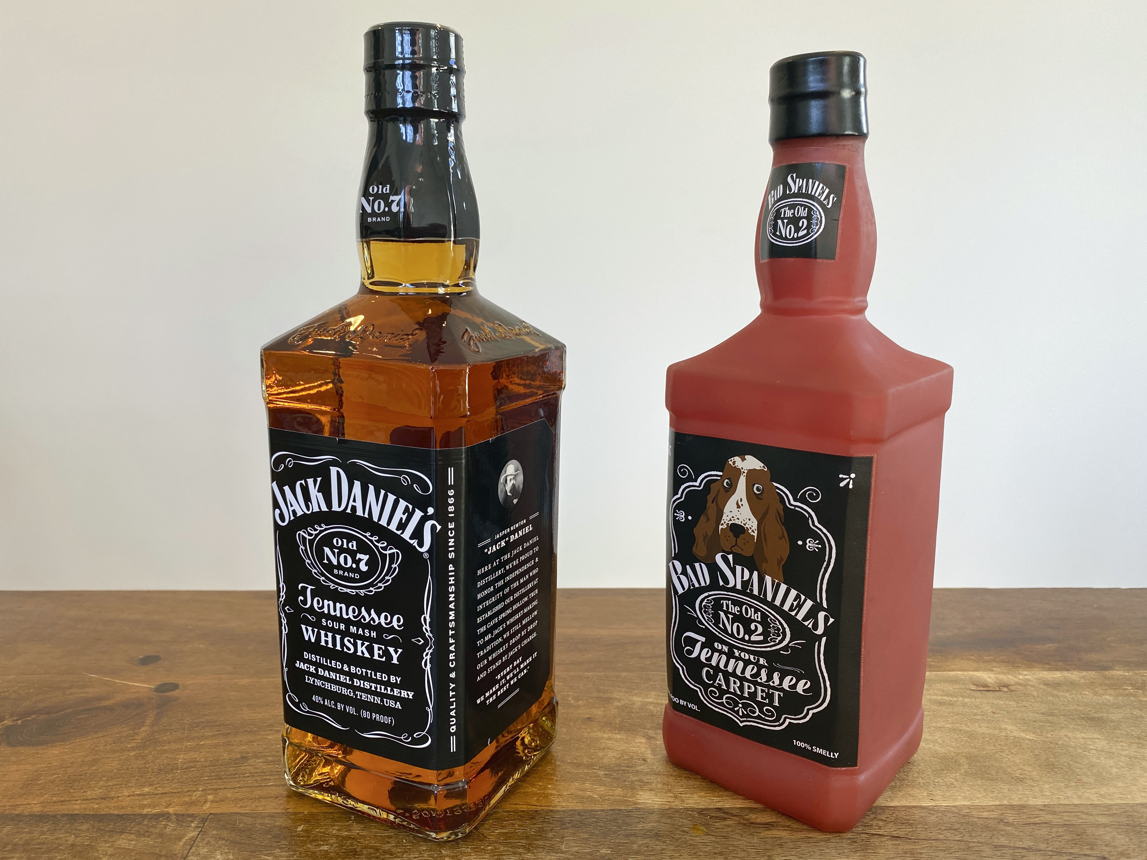 A Jack Daniel&#039;s bottle and knockoff dog toy. 