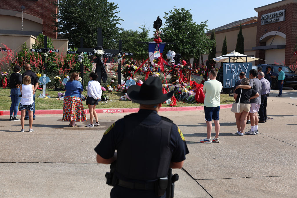 people visit the memorial set up near the Allen Premium Outlets mall. 