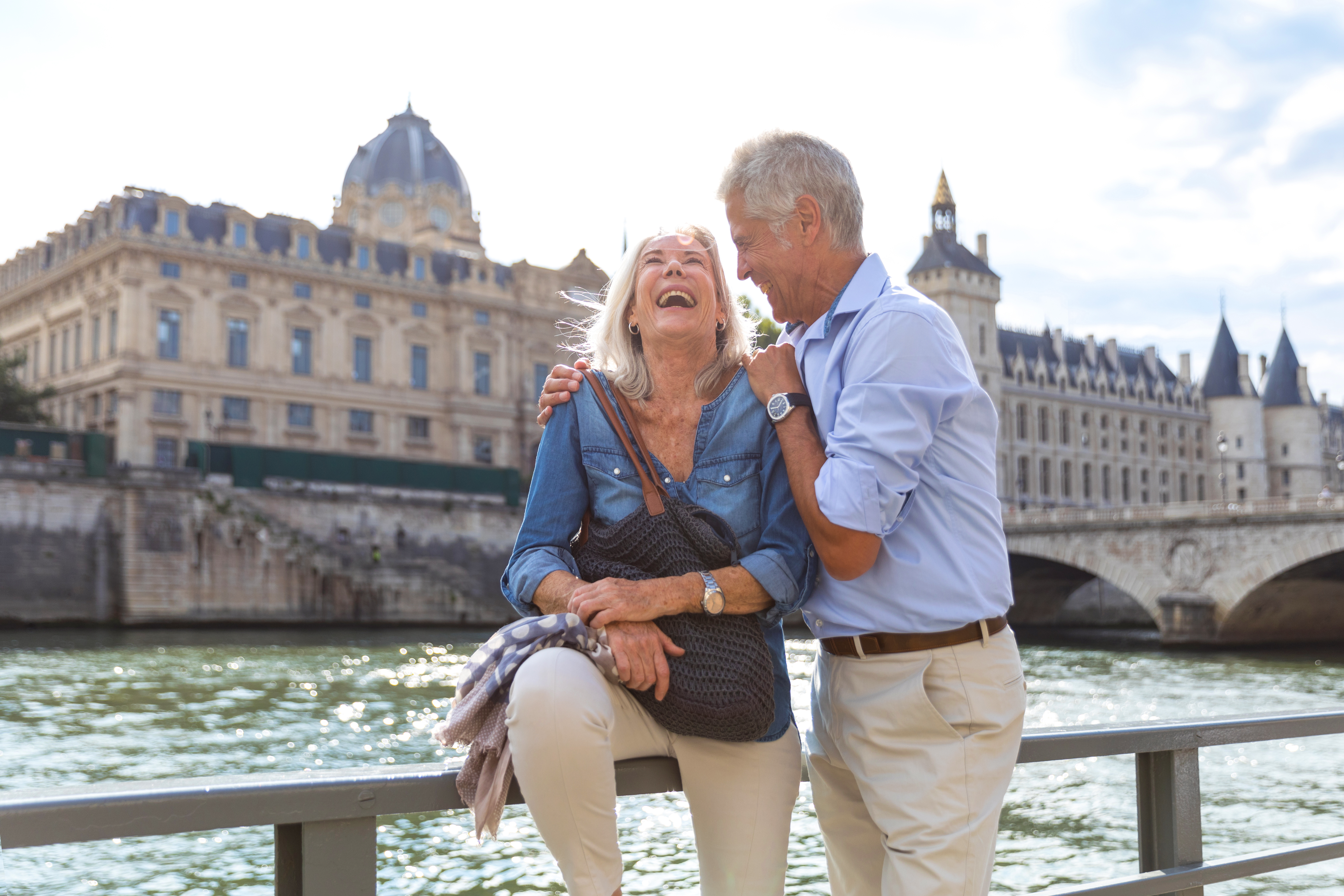 An older couple laughing in Paris